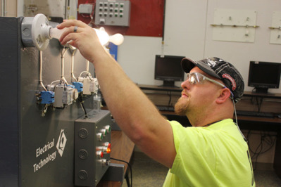Electrical Technology student changing bulb