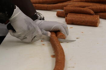 Hinds student cuts sausage
