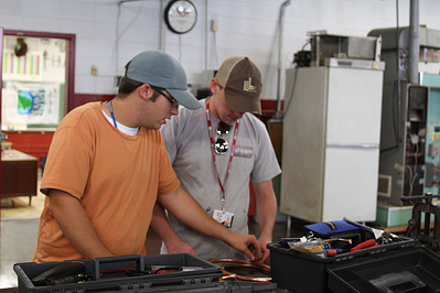 Male students working in the HVAC lab